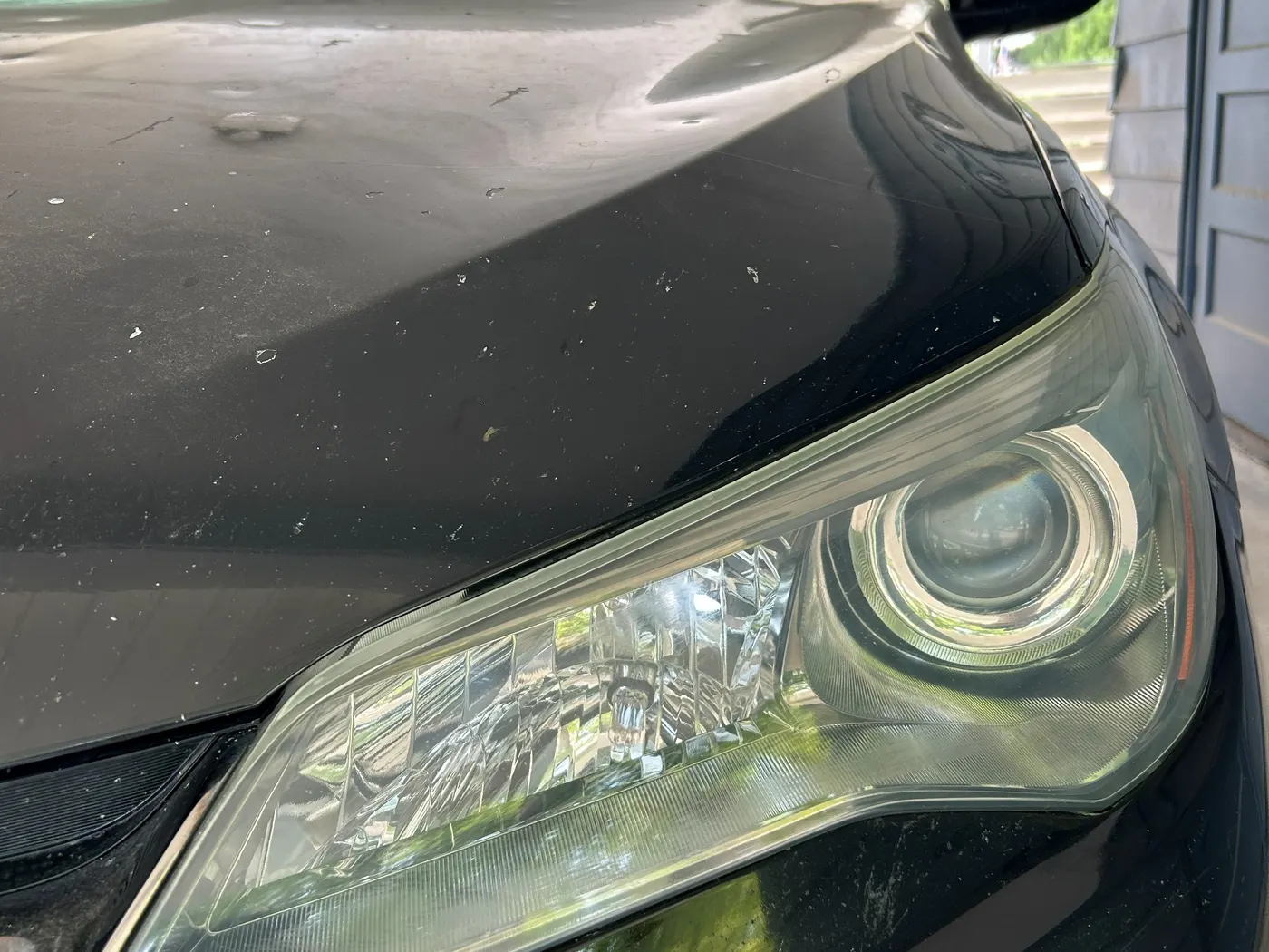 The same driver-side headlight after restoration and UV coating, clear and glossy