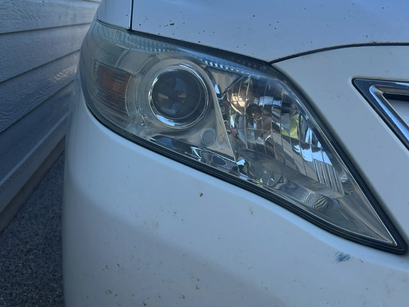 The same passenger-side headlight after restoration, fully transparent with a mirror-like finish