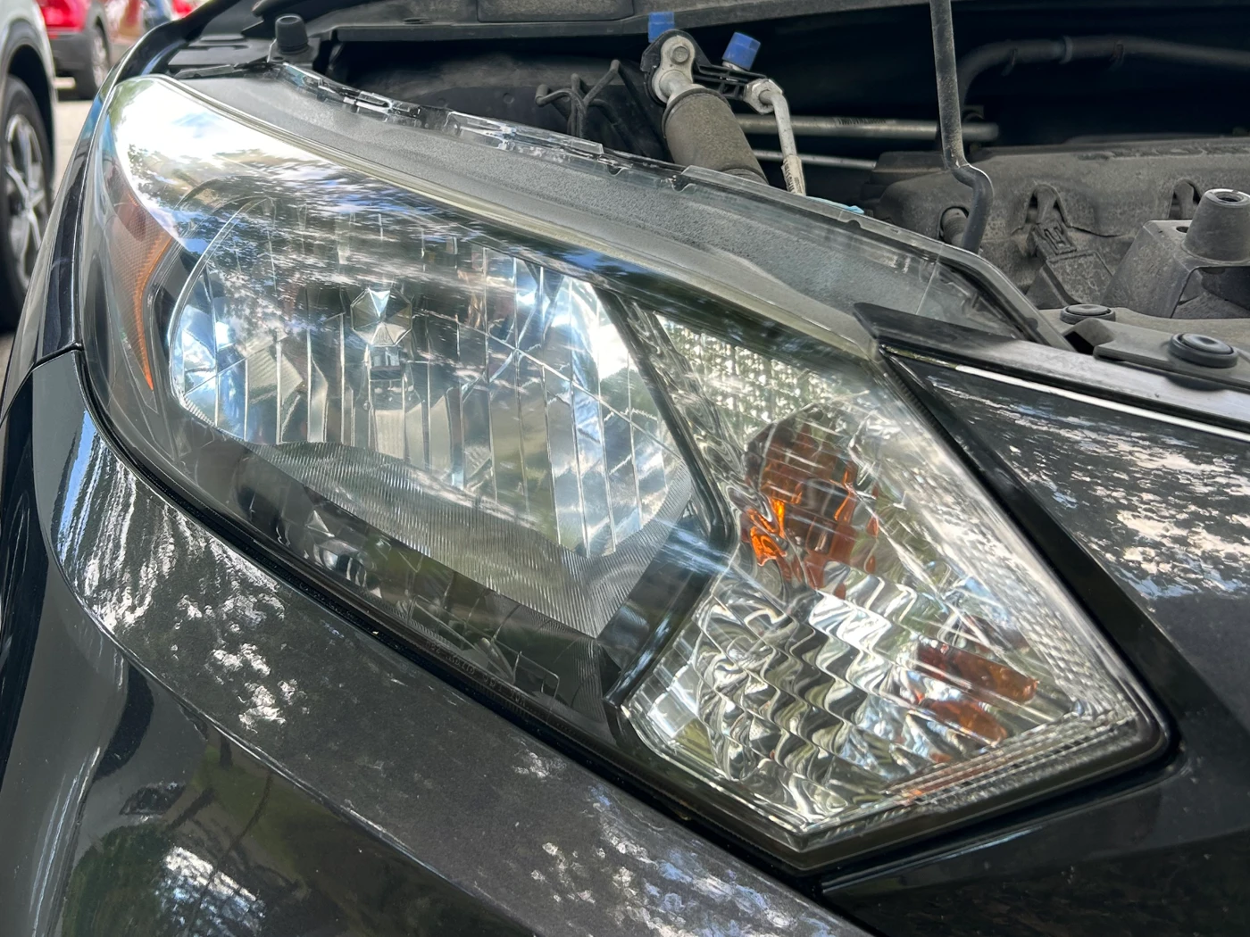 The same Hyundai headlight after restoration, the lens clear with the reflector and bulb sharply visible